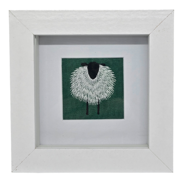 Small framed sheep on emerald green linen