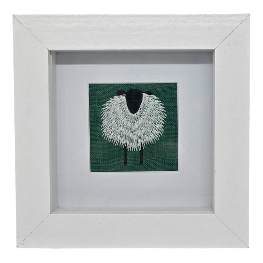 Small framed sheep on emerald green linen